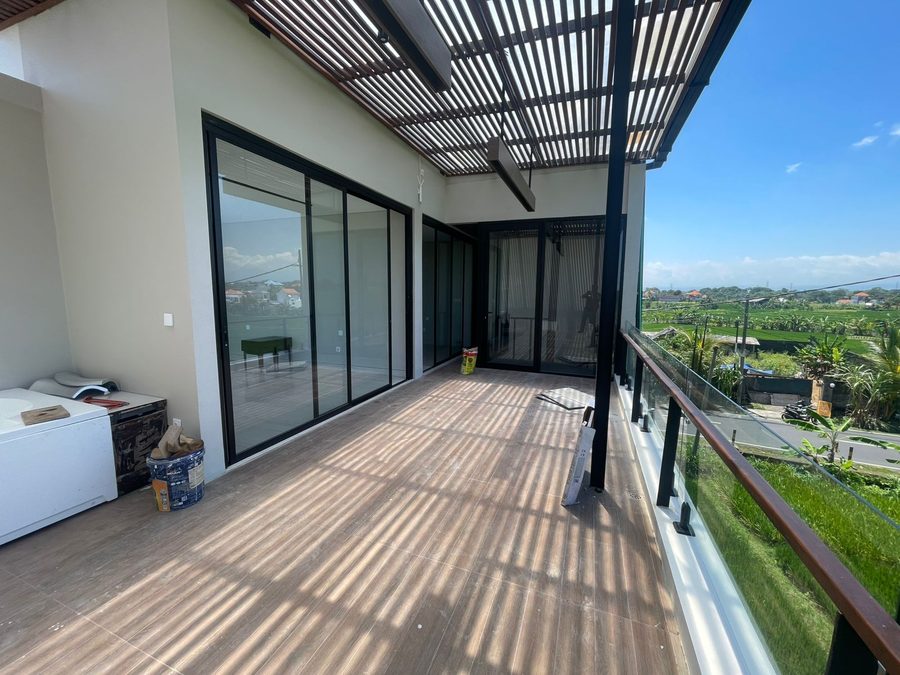 Villa Bali dengan railing kaca frameless dan pintu kaca geser